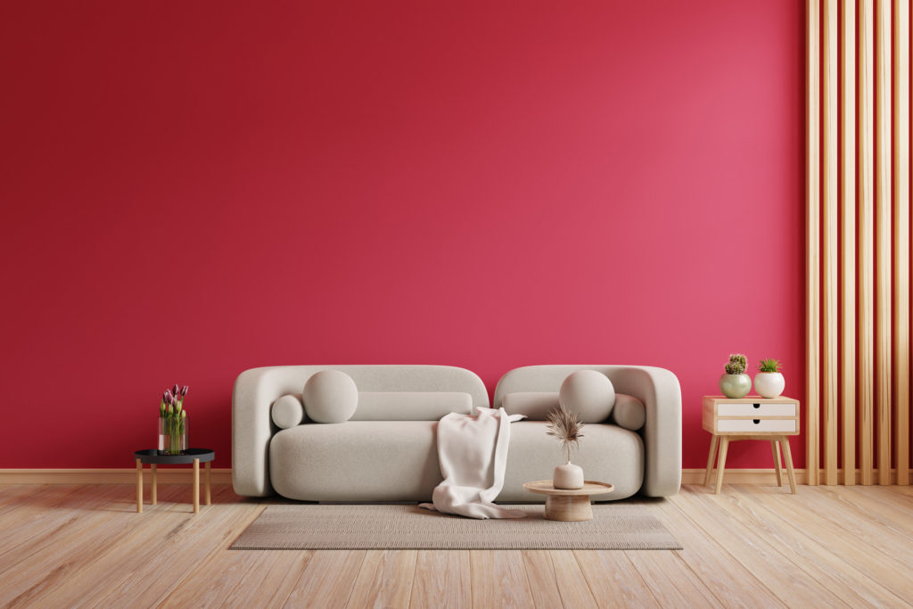A living room with a red wall