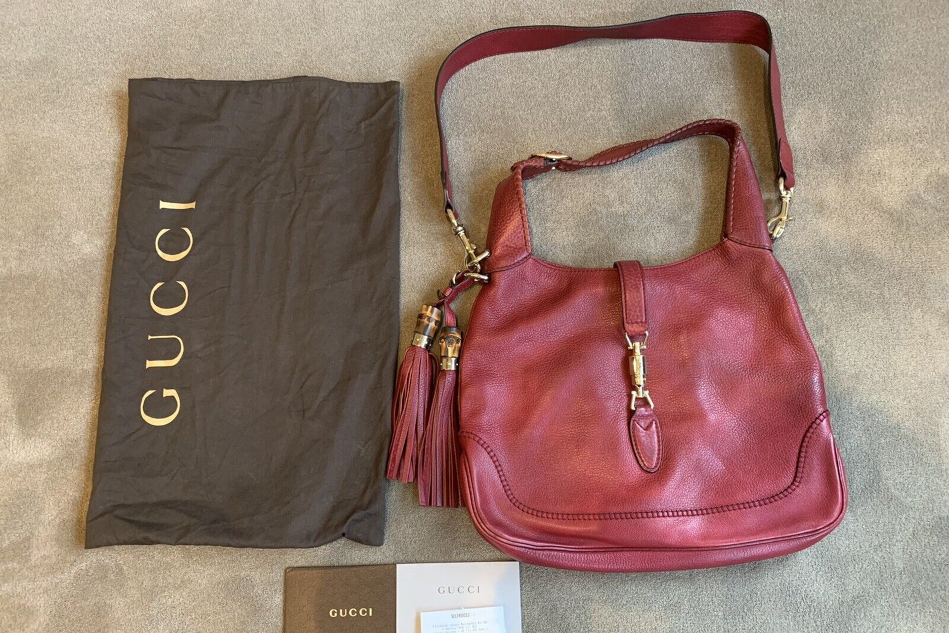 Red handbag with dust bag