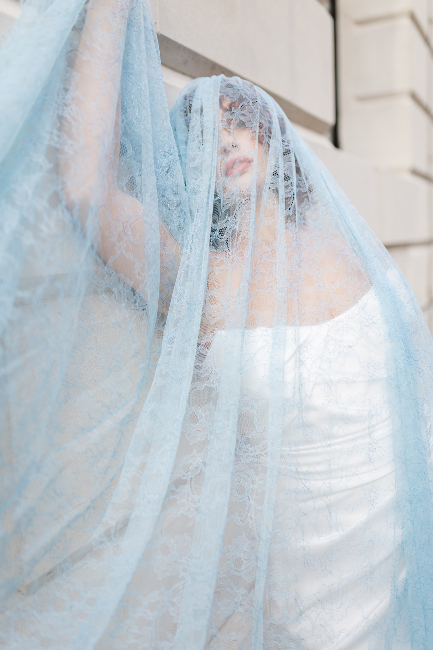Woman in wedding dress and blue veil