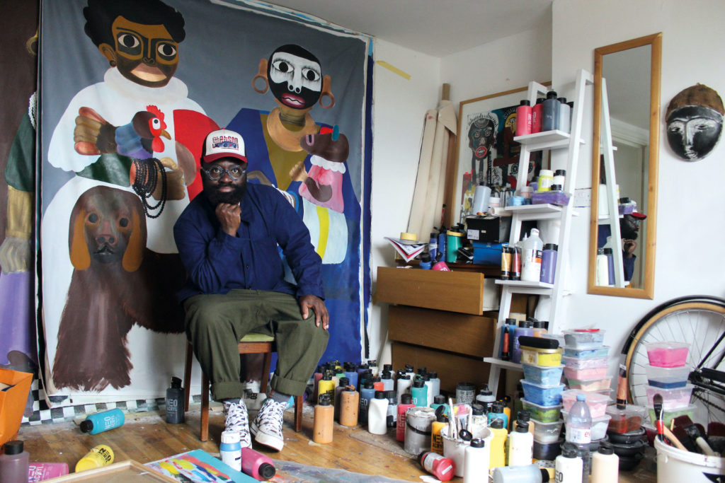 Artist Kojo Marfo in his studio with a painting behind him, surrounded by paint pots