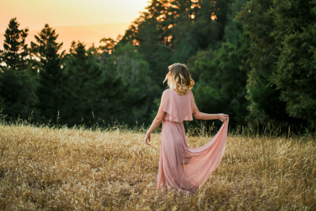 Woman in pink black tie wedding guest dress