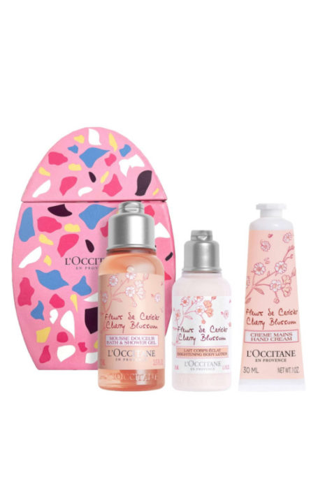 Travel skincare products in front of pink oval box