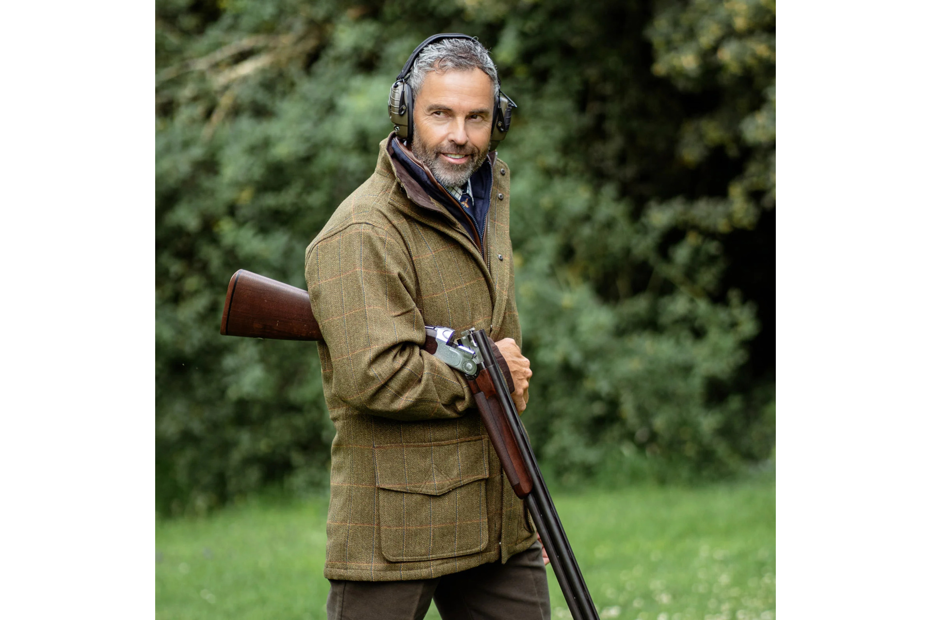 Man in hunting jacket with gun