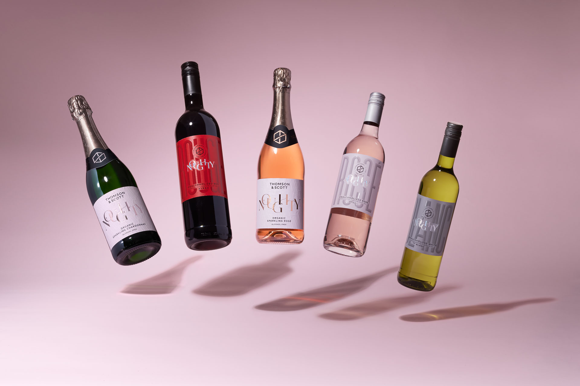 Noughty wine products against a pink background