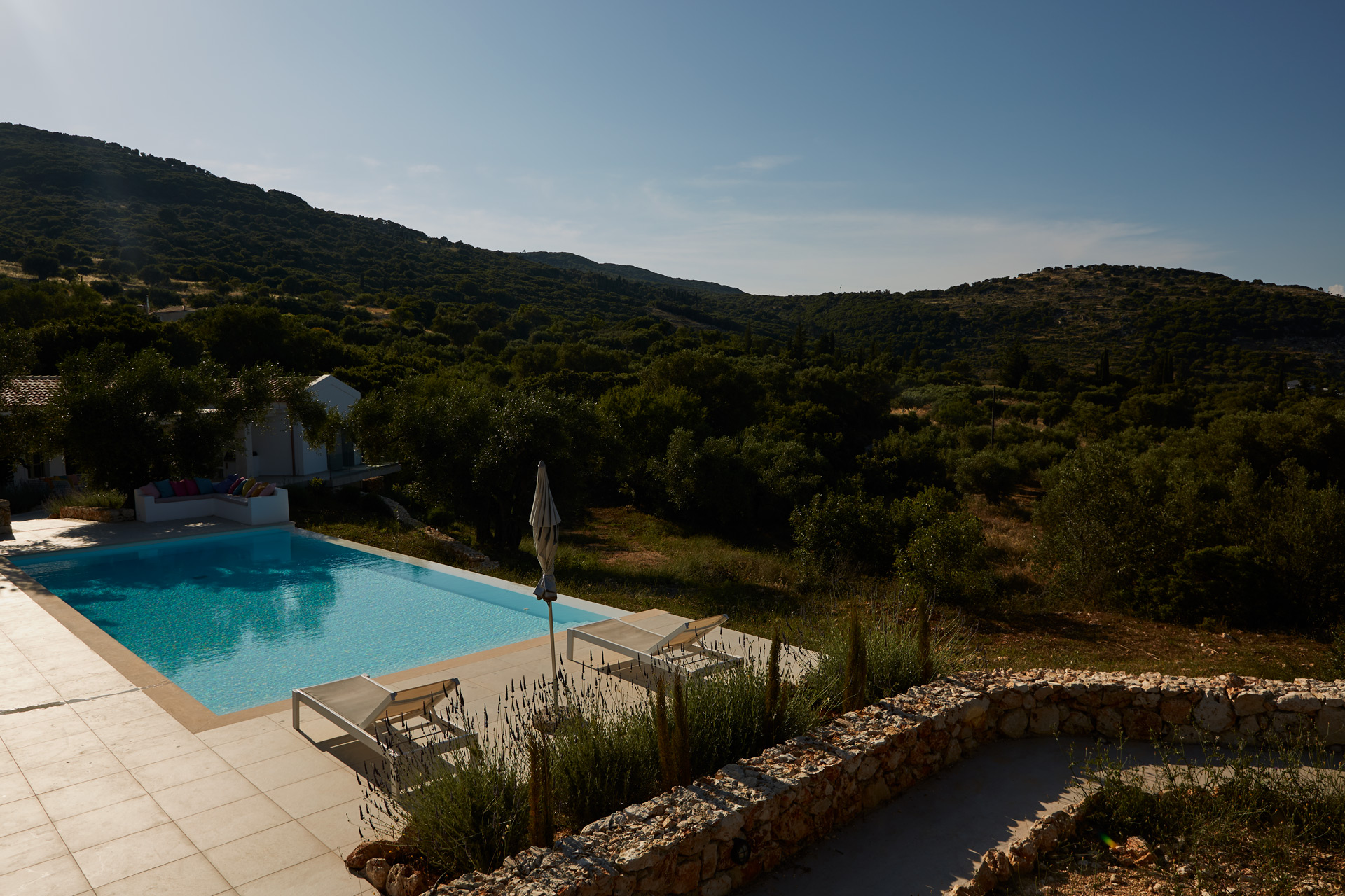 Aerial view of infinity pool overlooking the Greek hills