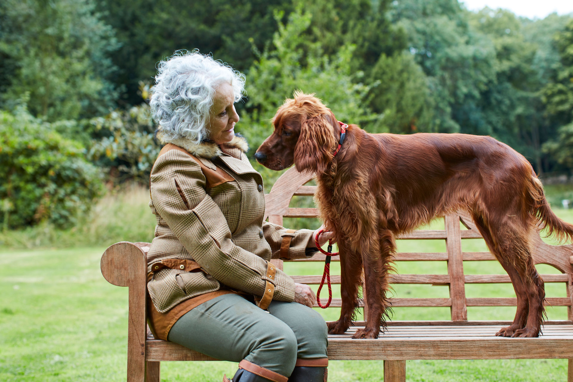 Philippa Gregory with dog sitting on bench