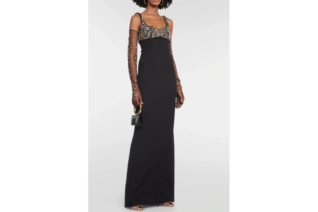 Woman in black tie wedding guest dress and gloves