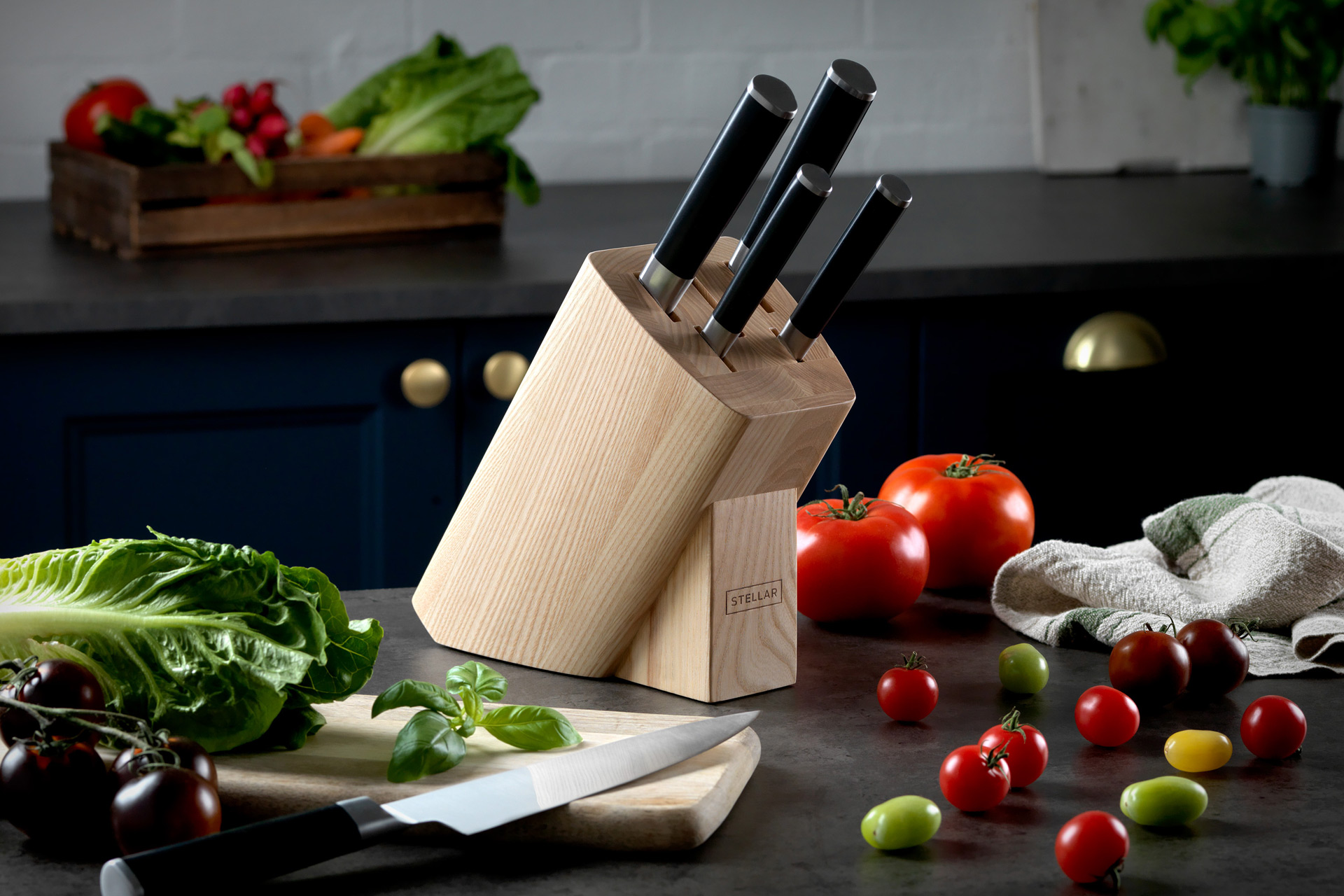 Wooden block of knives on black marble countertop