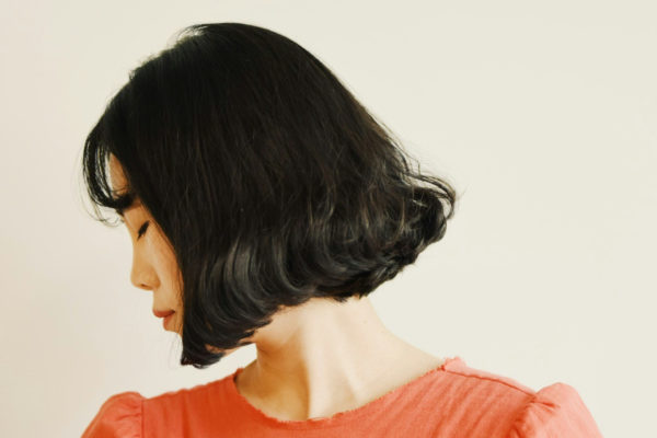 Girl with French bob looking to side