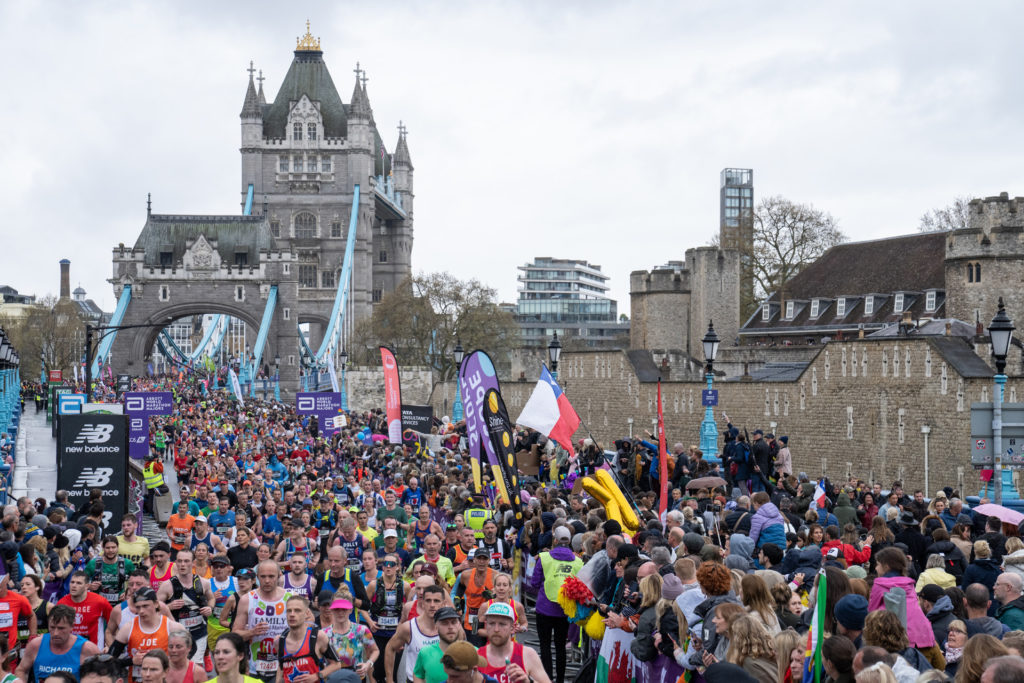 Mass participants crossing Tower Bridge and passing the Tower of London during The TCS London Marathon on Sunday 23rd April 2023.