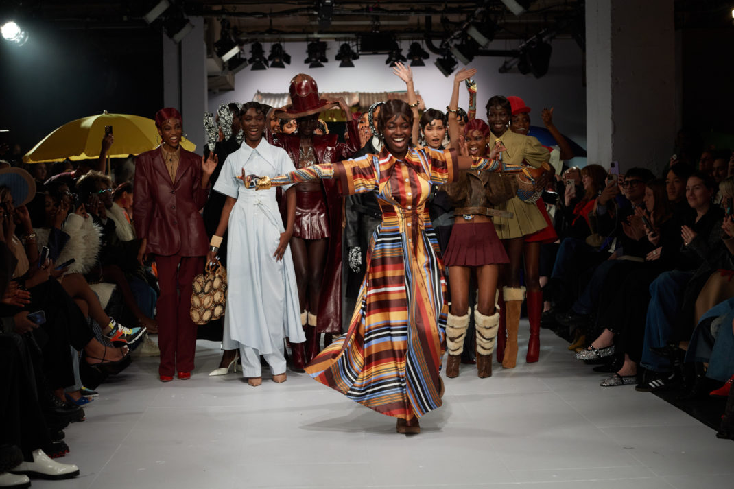 Models coming together on runway after show