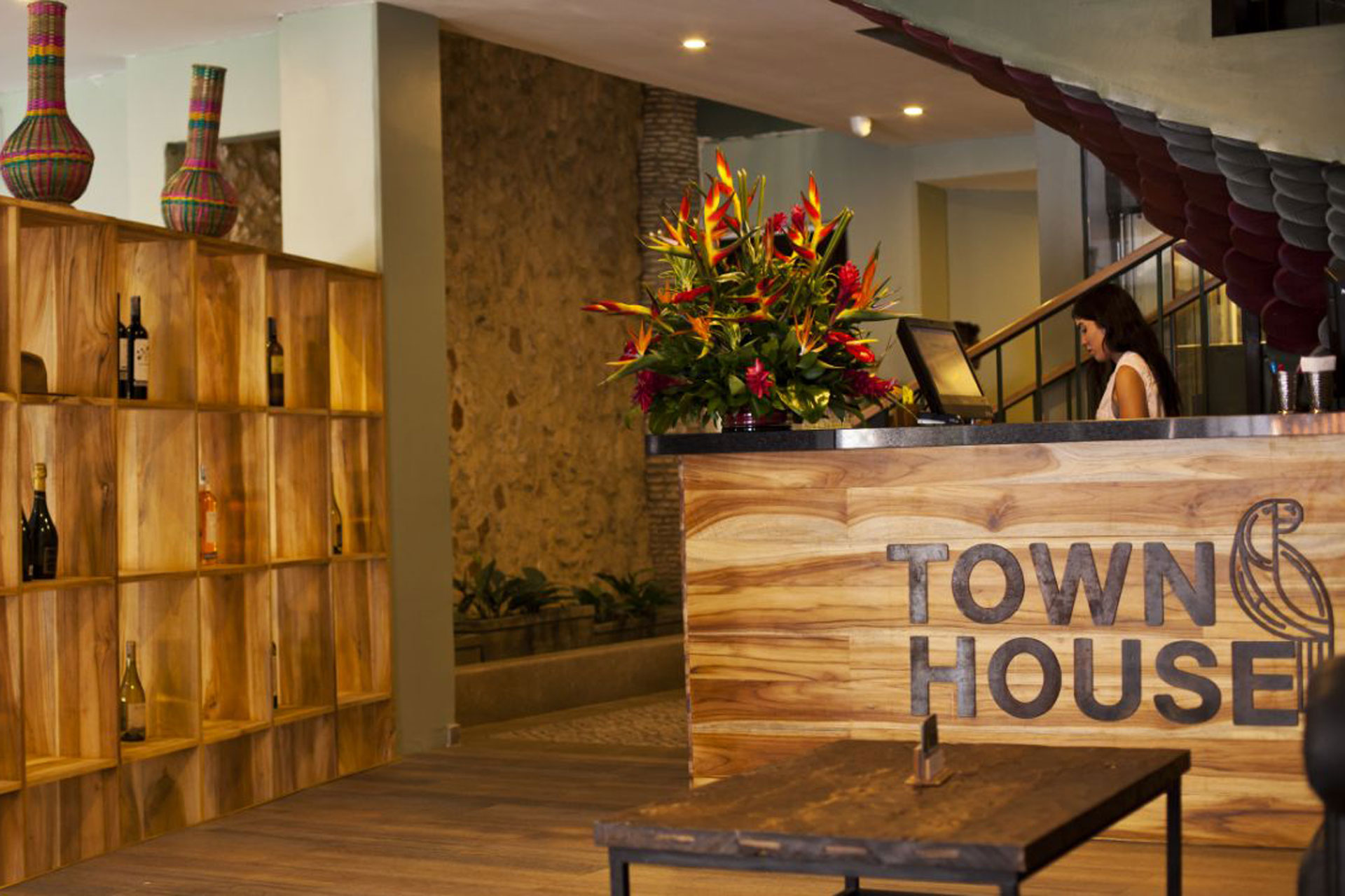 Lobby with wooden shelves and bright bouquets of flowers