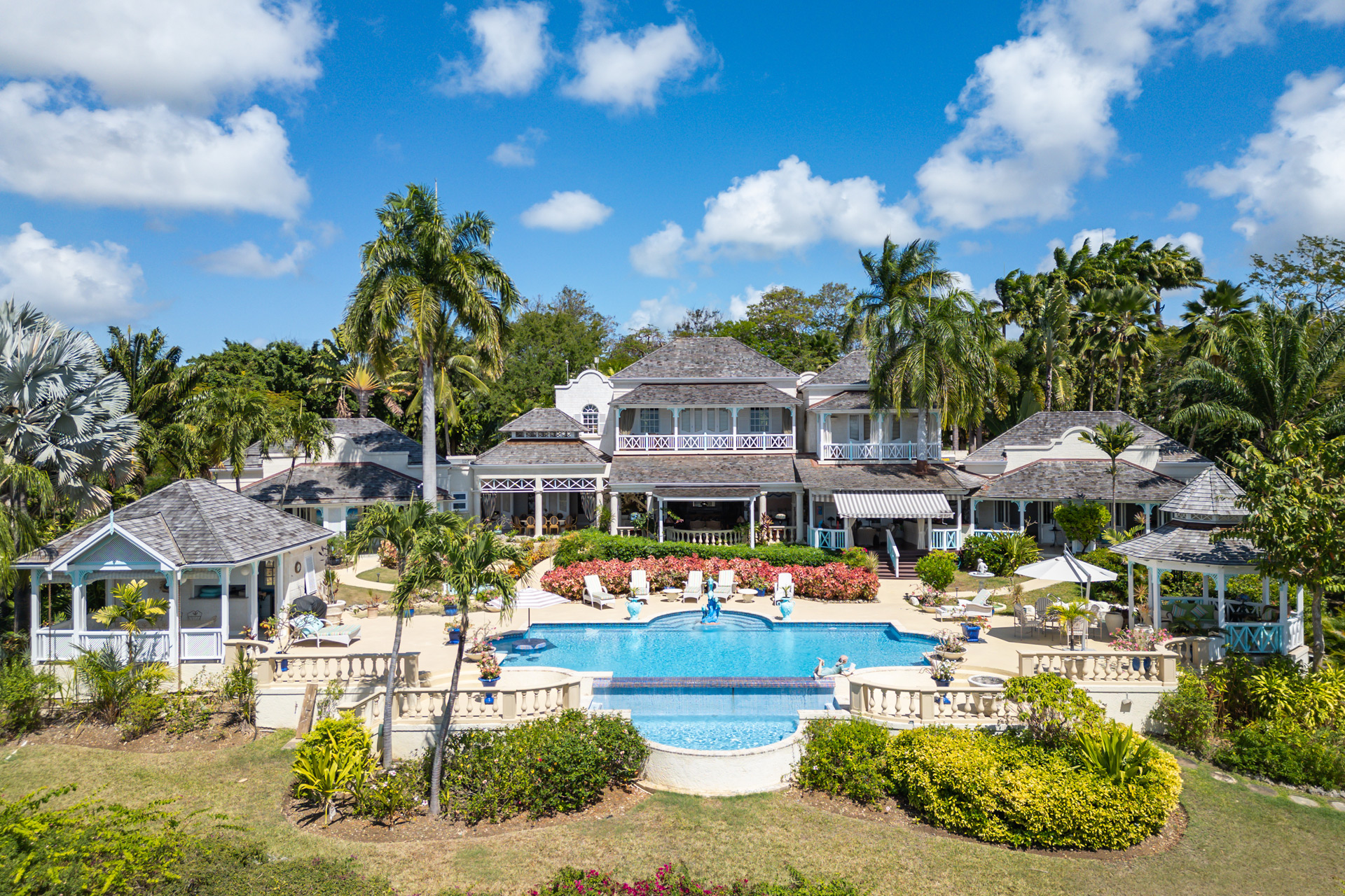 Exterior view of Barbados mansion, with swimming pool, terraces and gardens.