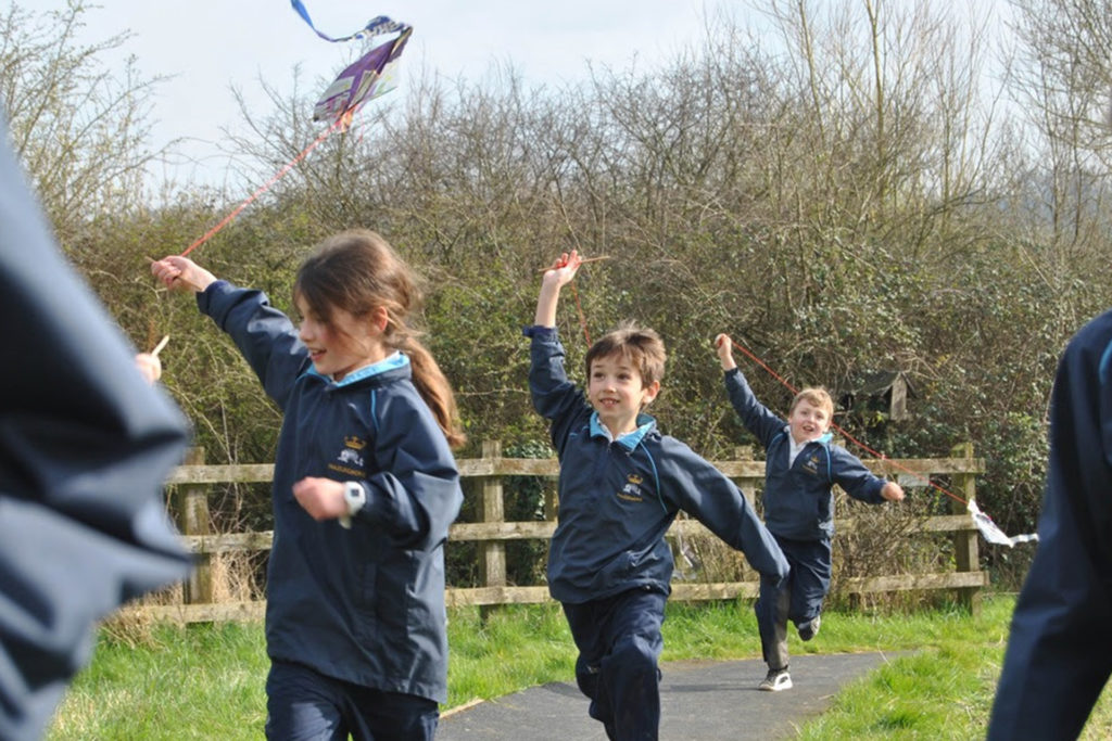 Hazlegrove pupils running with their recycled kites