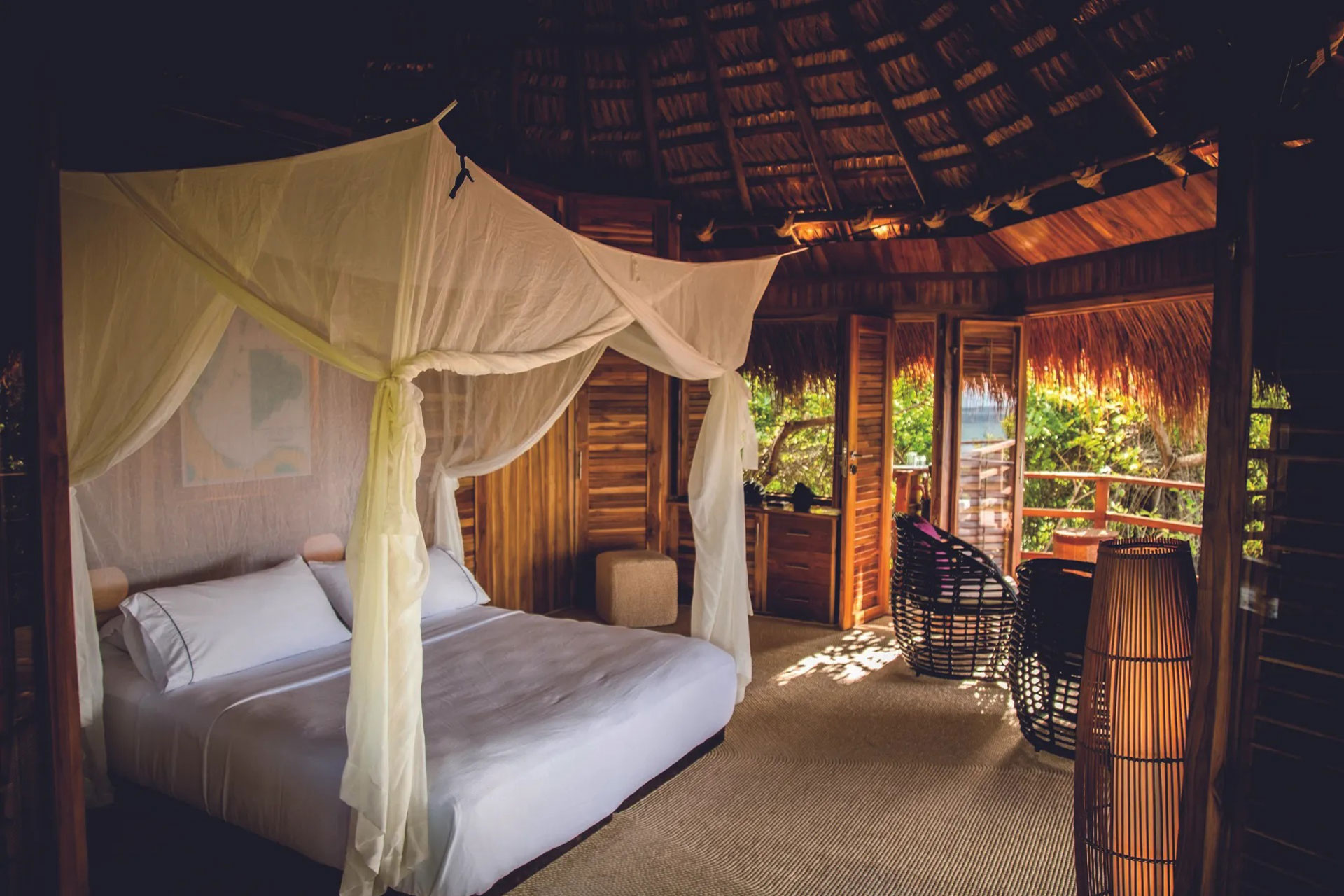 Treetop hotel room with four poster bed.