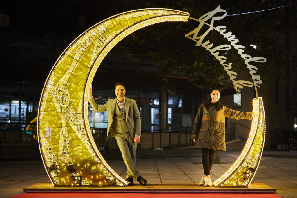 Two people posing with Ramadan Lights in London