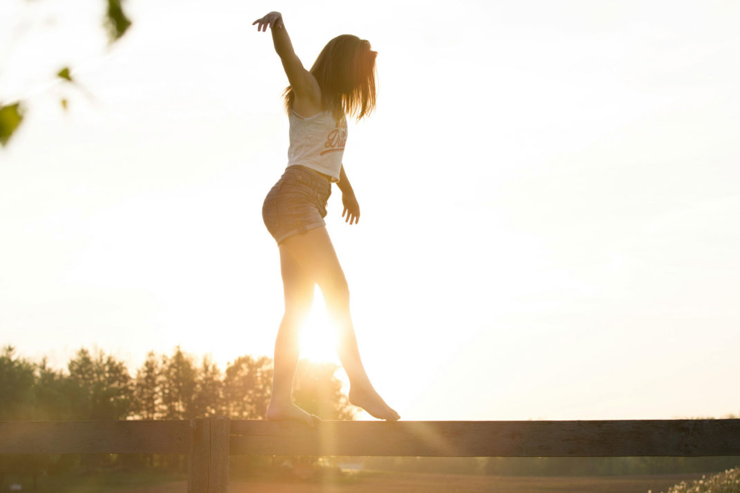 Woman walking along a log