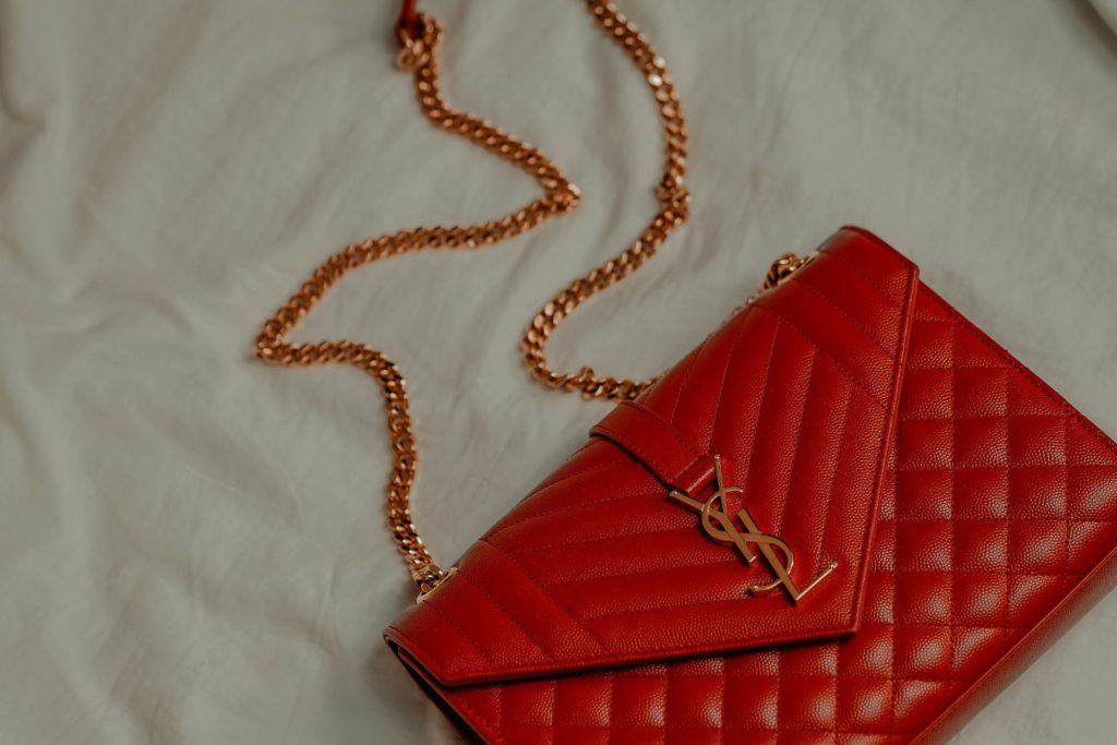 Red YSL bag on a white background.