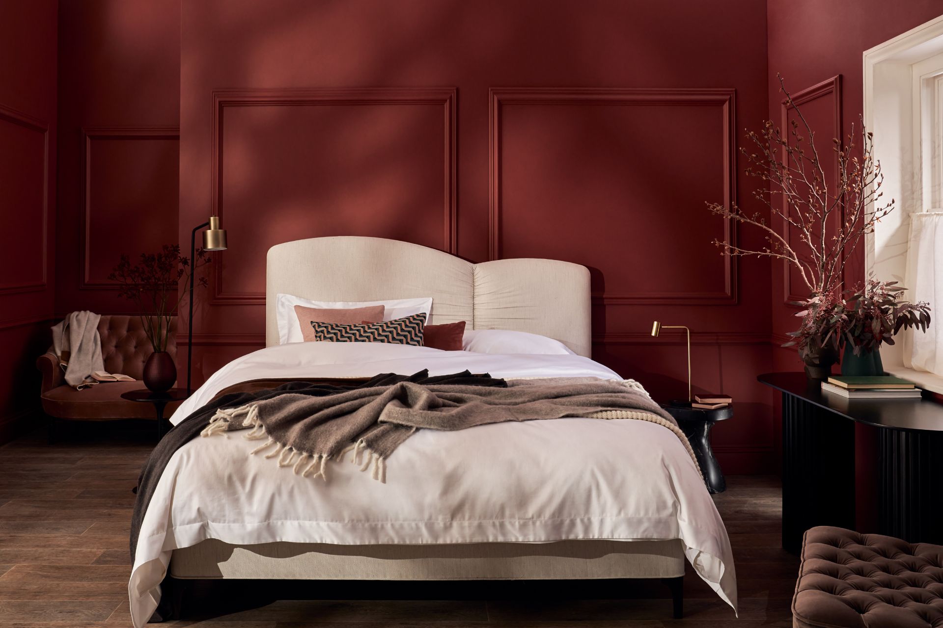 Burgundy bedrom with curved cream bed 