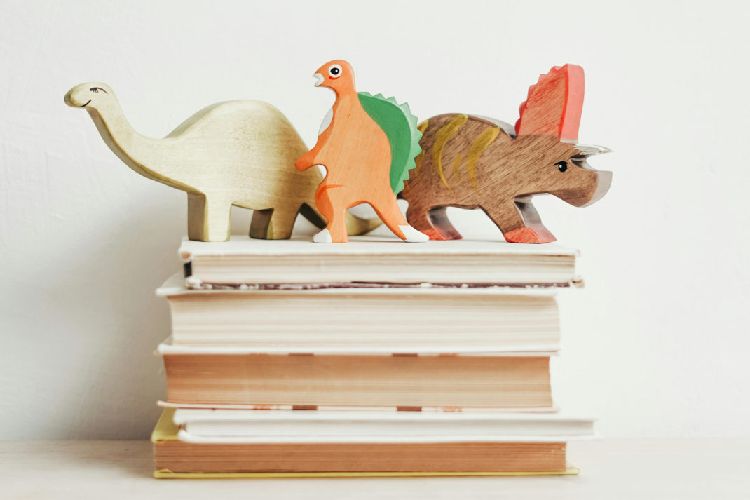 Stacked books with children toys on top