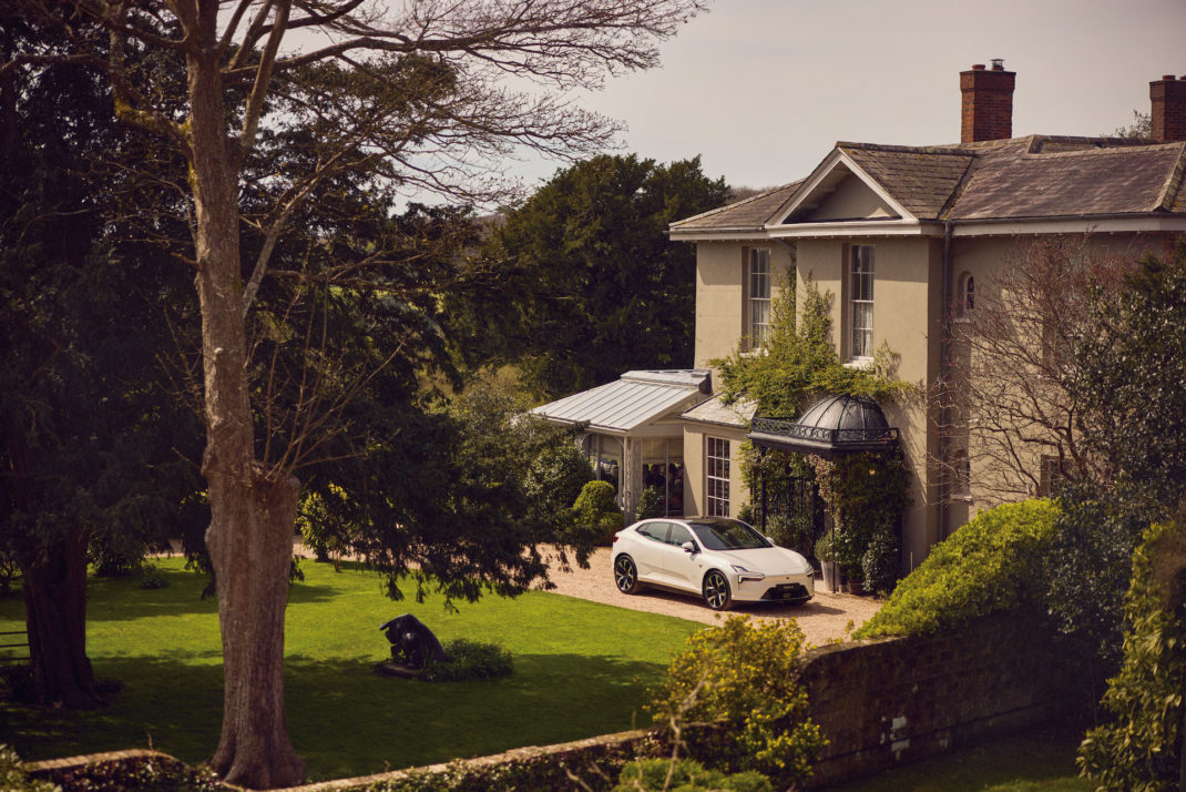 The Pig in the South Downs with white Polestar parked outside C&TH x Polestar Sustainable Hotel of Year Award 2024