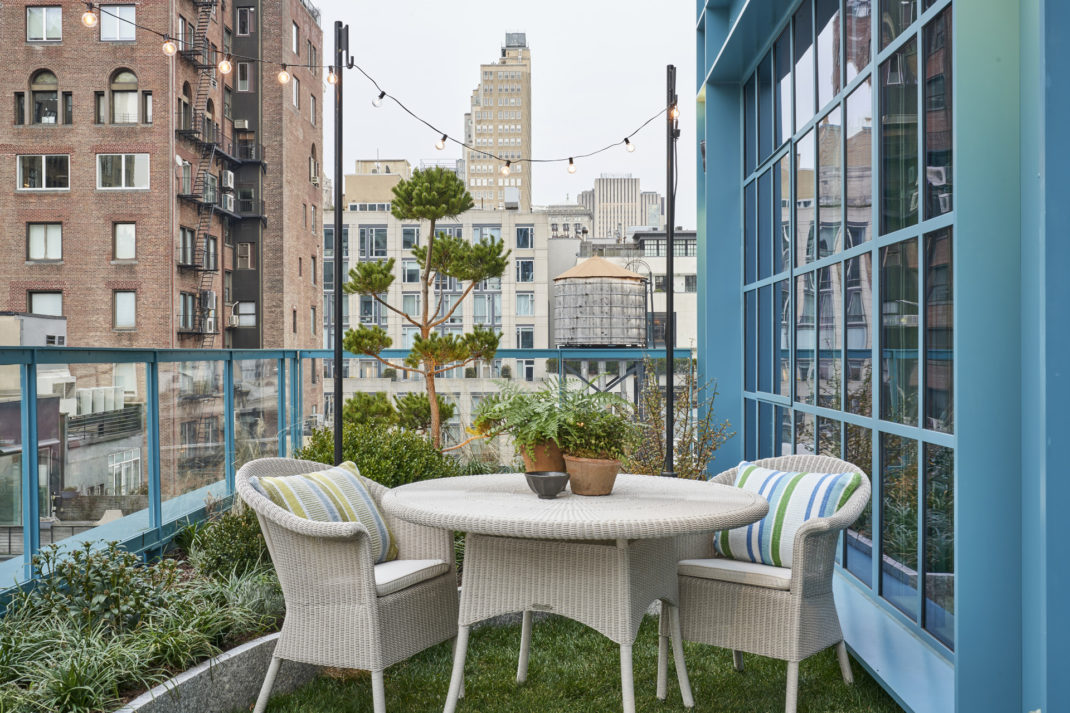 A balcony backdropped by NYC
