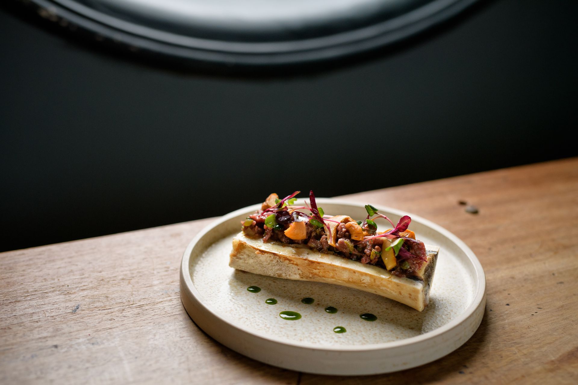 Plate of mushroom toast with green dressing.