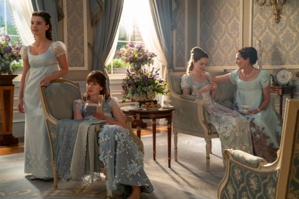 (L to R) Florence Hunt as Hyacinth Bridgerton, Claudia Jessie as Eloise Bridgerton, Hannah Dodd as Francesca Bridgerton, Ruth Gemmell as Lady Violet Bridgerton sat in regencycore interiors room