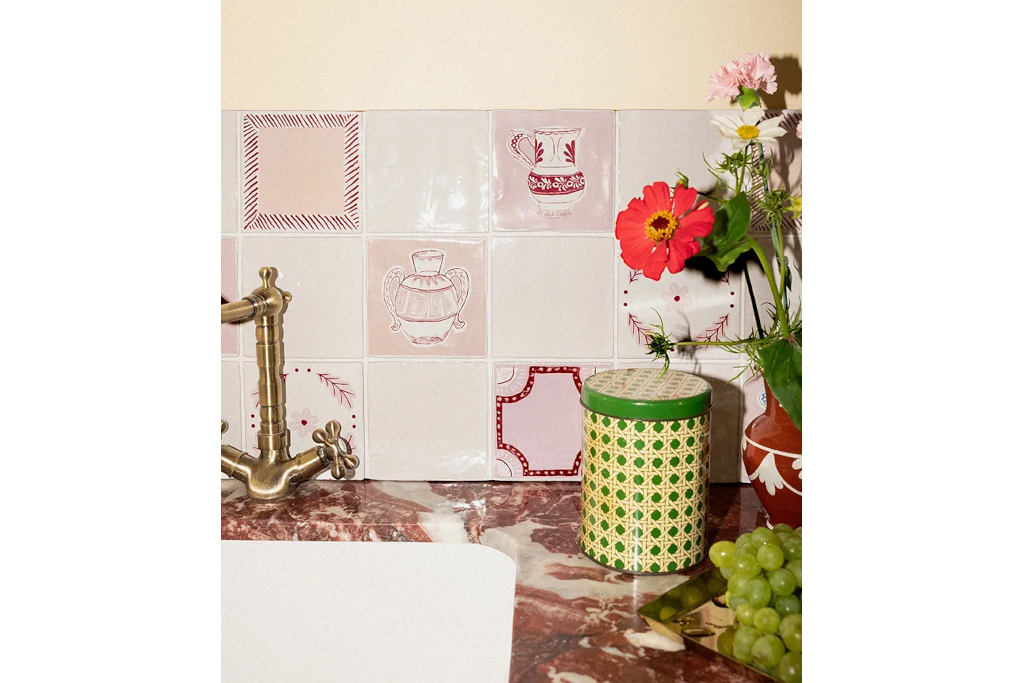 Pink marble sink with tiles behind it