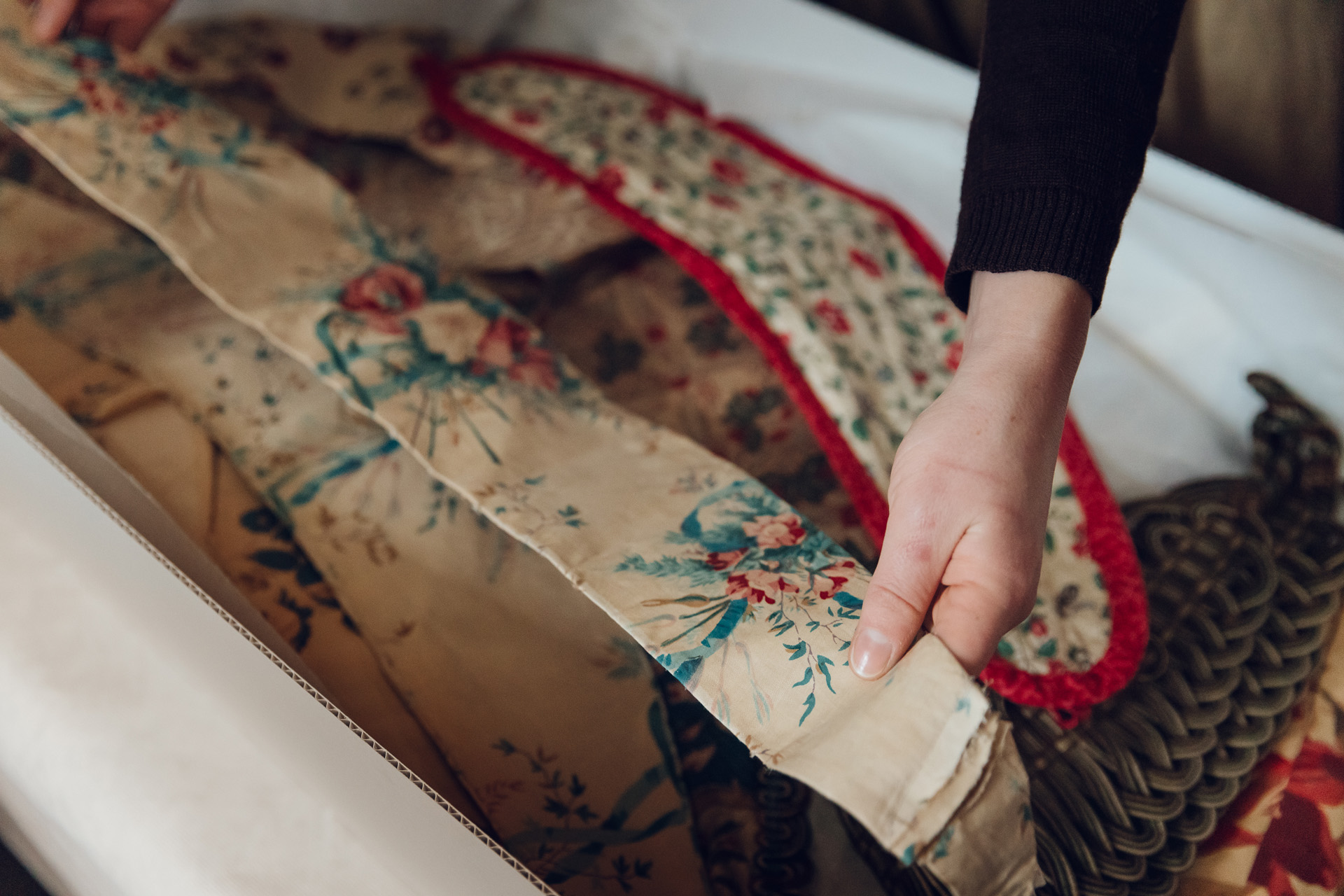 A hand holding some textiles