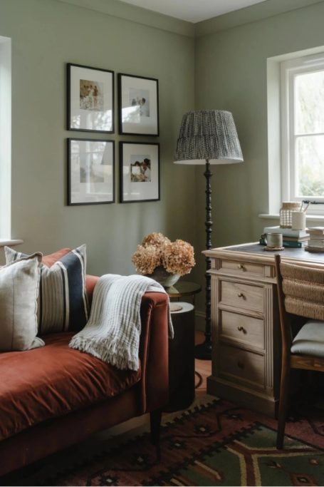 Green sitting room with rust sofa
