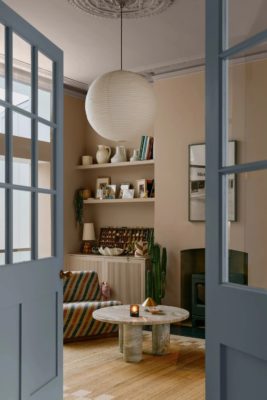 Blue doors leading to neutral sitting room