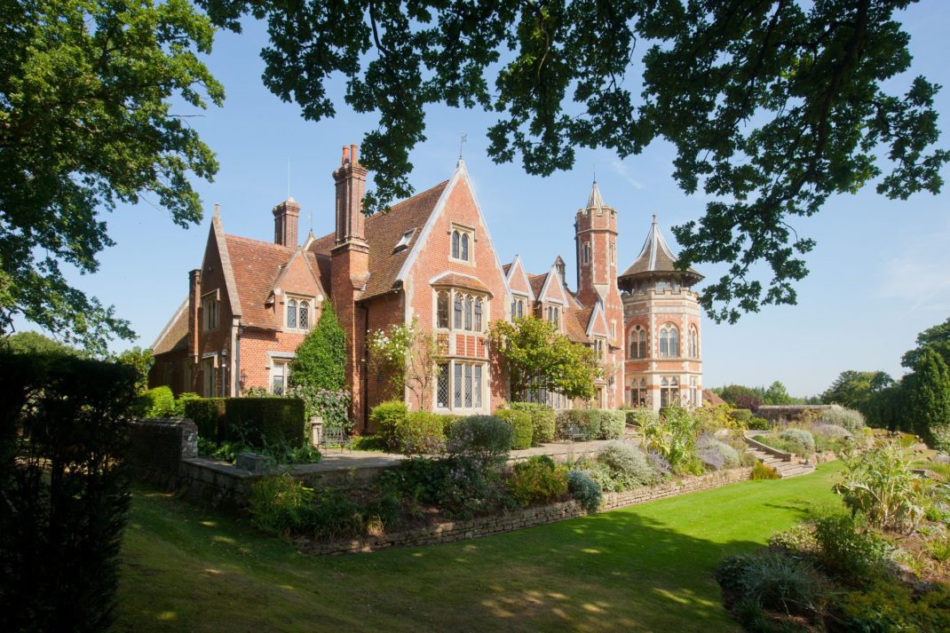 Exterior of red brick Victorian country manor.