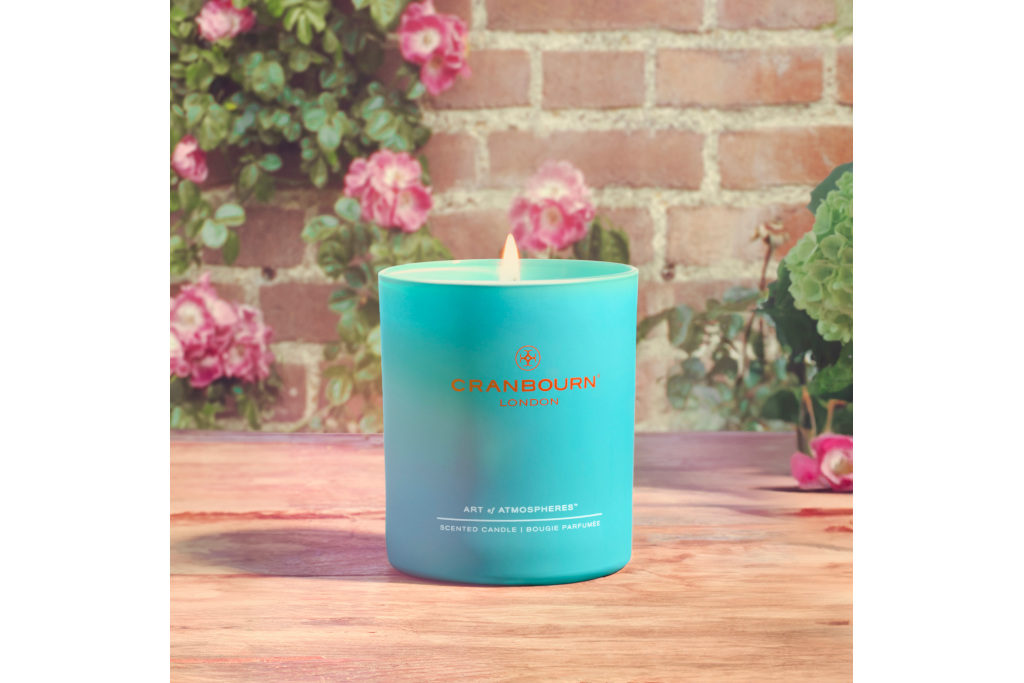 Blue candle on wooden and brick background