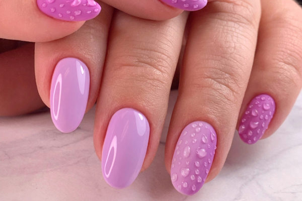 Hands with purple dew drop nails