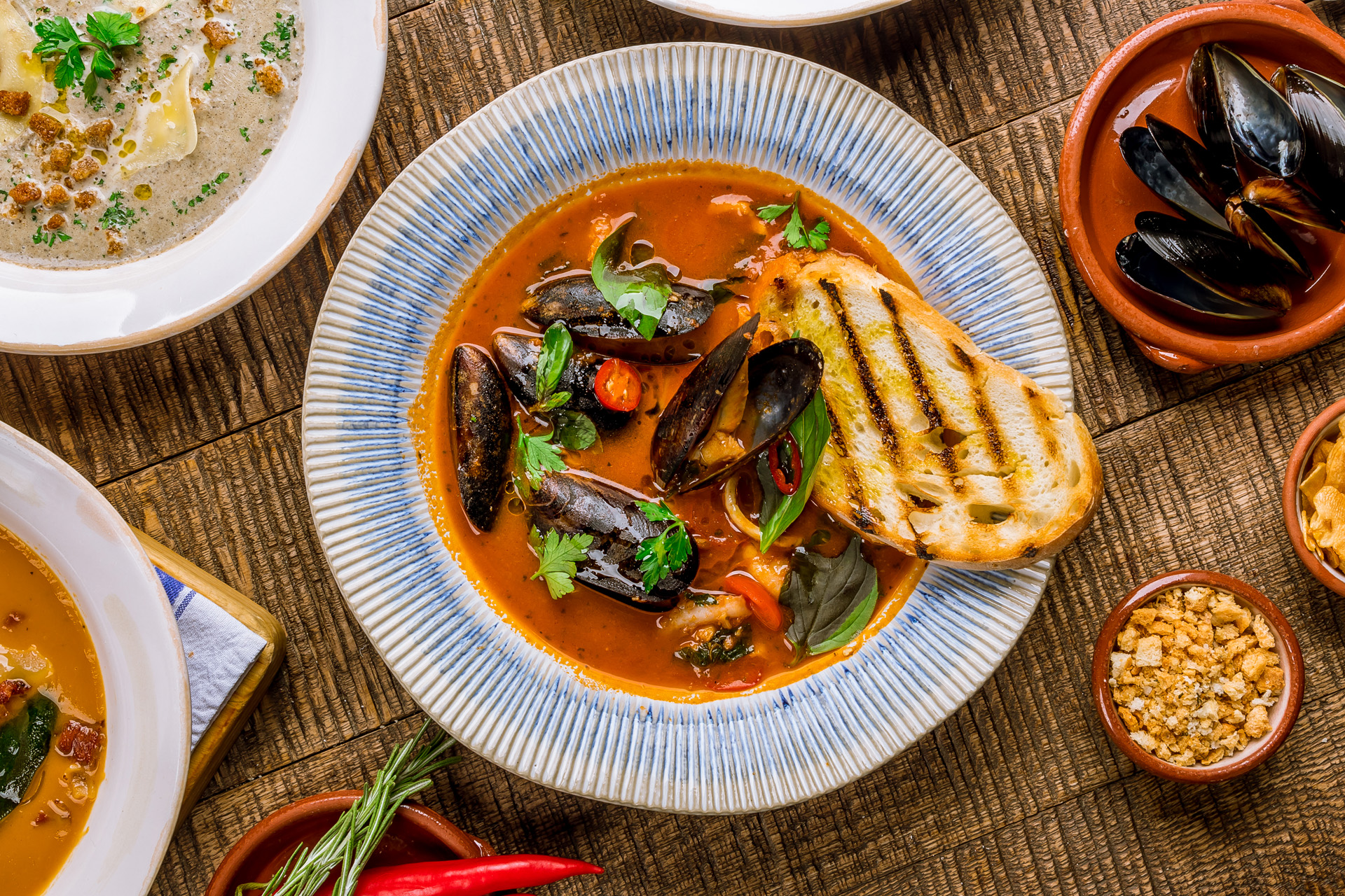 A bowl of Cioppino with a slice of bread