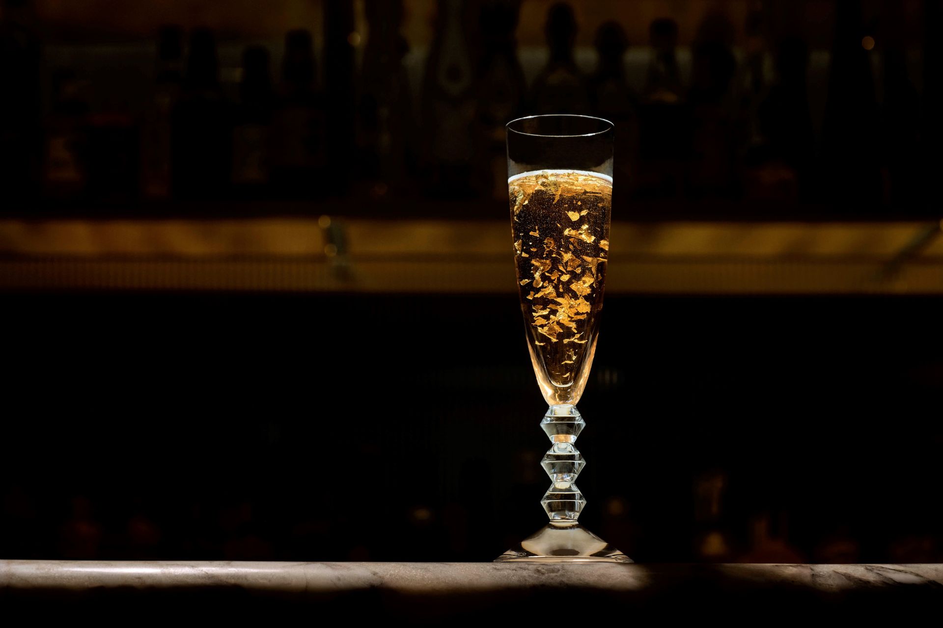 Gold-flecked cocktail in a Baccarat crystal flute