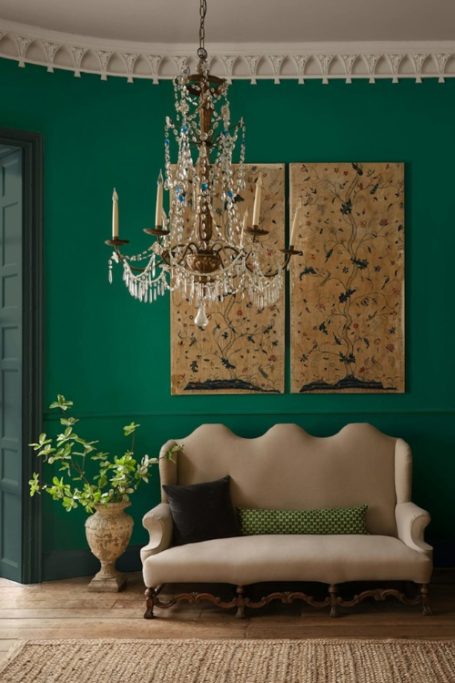 Green room with sofa and gold artwork