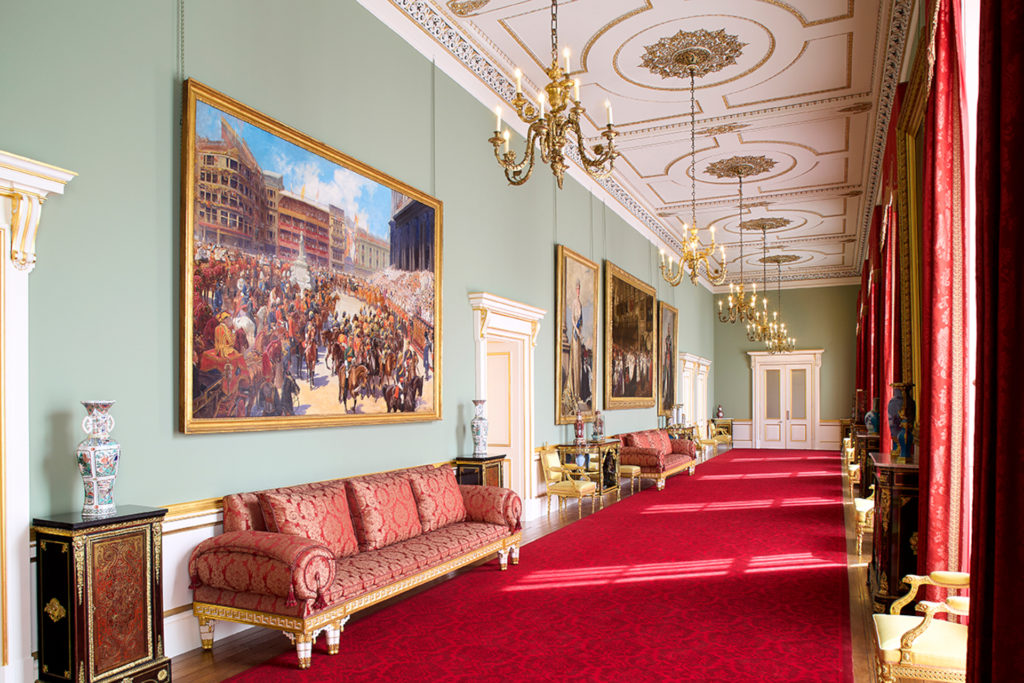 Principal Room in East Wing of Buckingham Palace, with red carpeted floors and green walls adorned with paintings