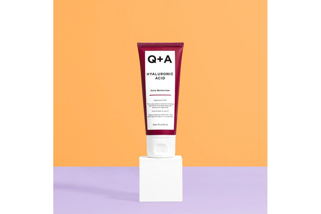 Burgundy and white bottle on orange and purple background
