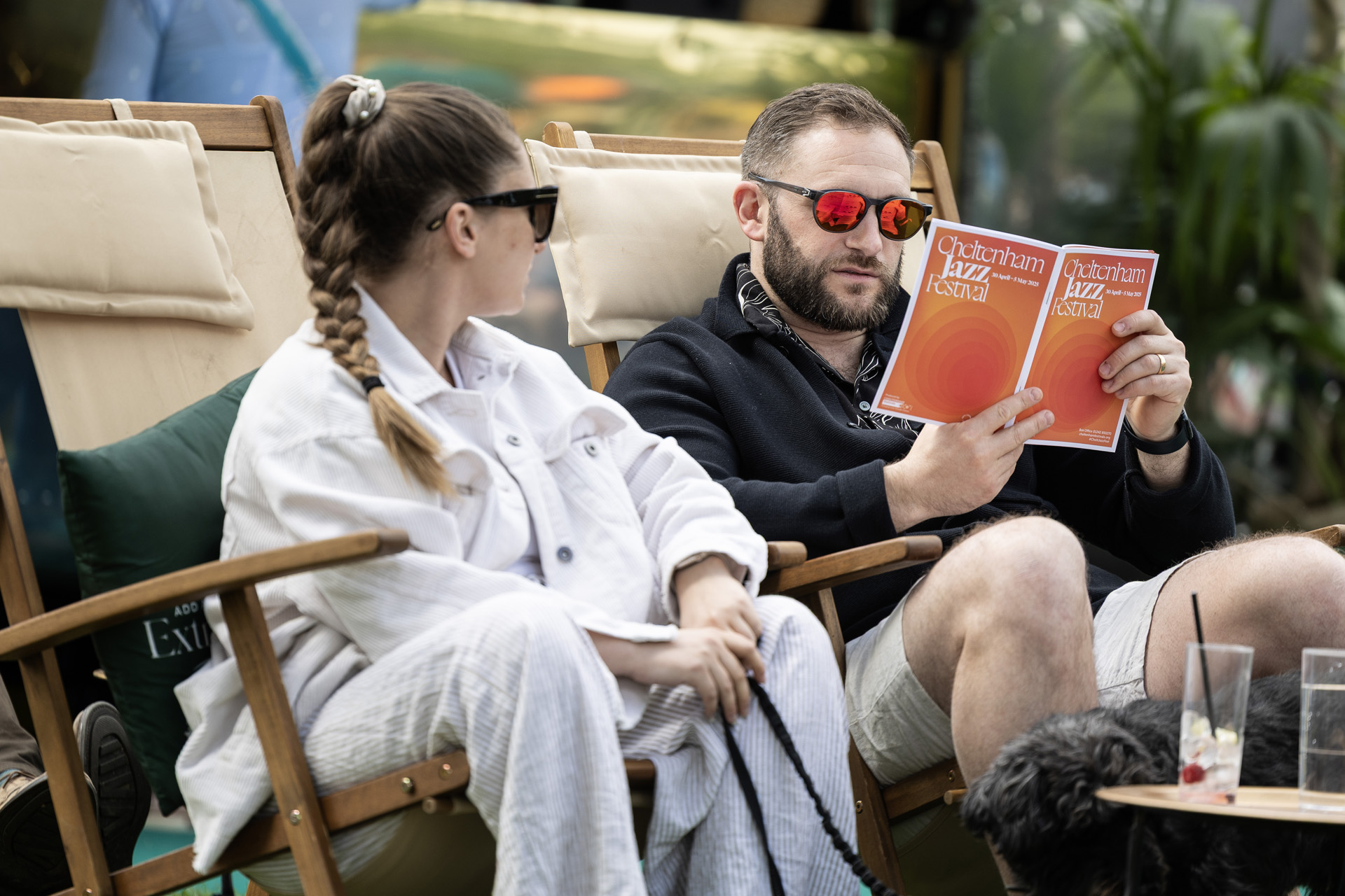 People at Cheltenham Jazz Festival reading the programme