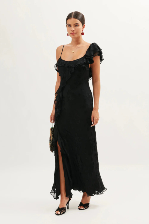 Woman in black wedding guest dress