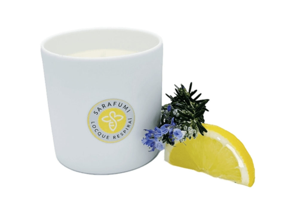 White candle next to lemon slice