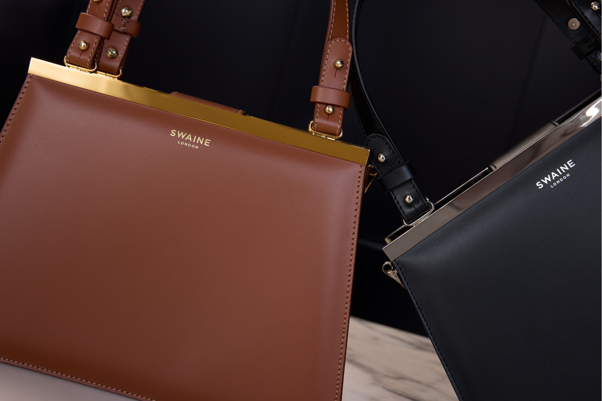 Tan an black leather handbags from Swaine.