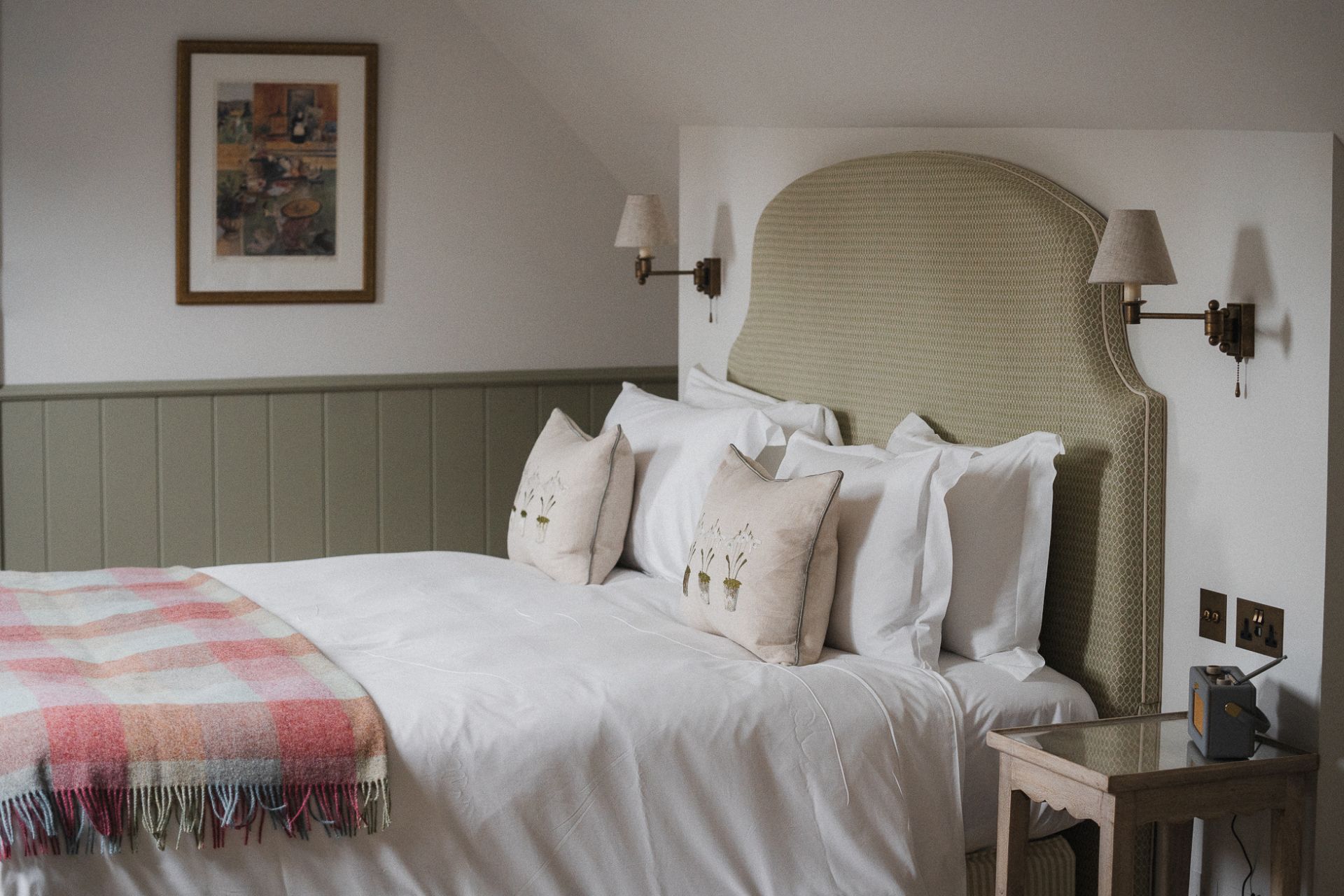 Bedroom with white linen and pink tartan blanket