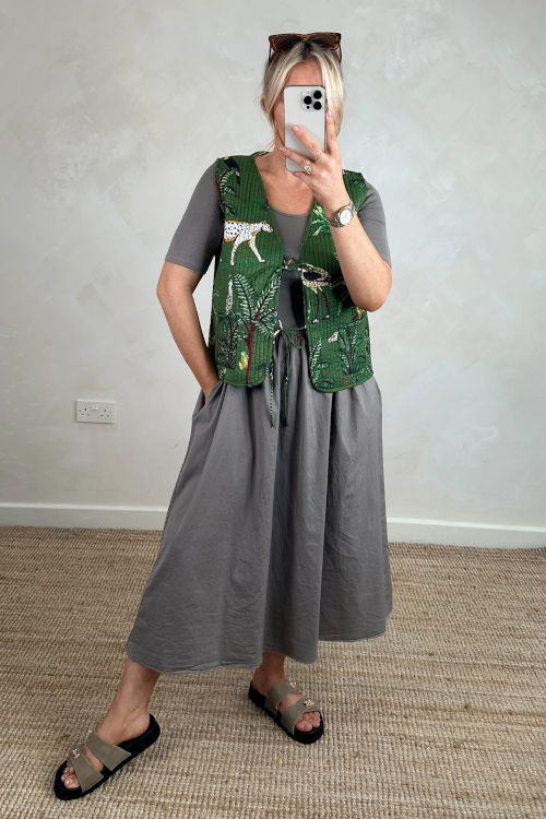 Woman wearing green tie front dress