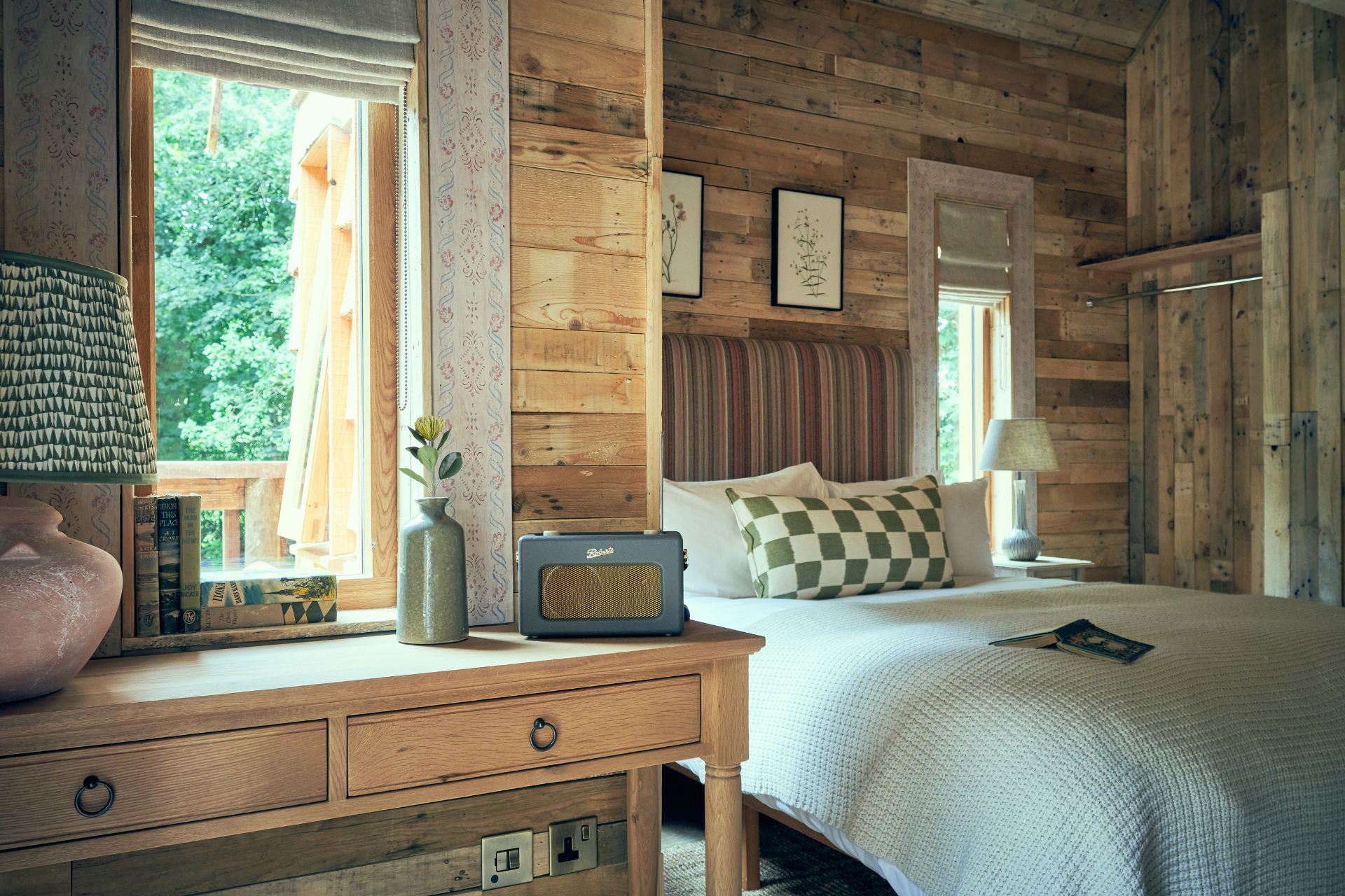 Wood-panelled bedroom with pale green sheets.