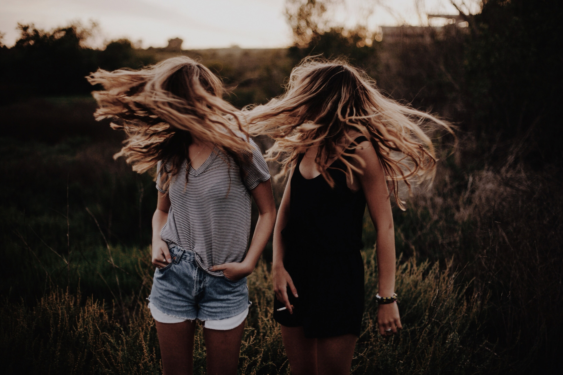 Two young women flicking their hair, dressed in Brandy Melville