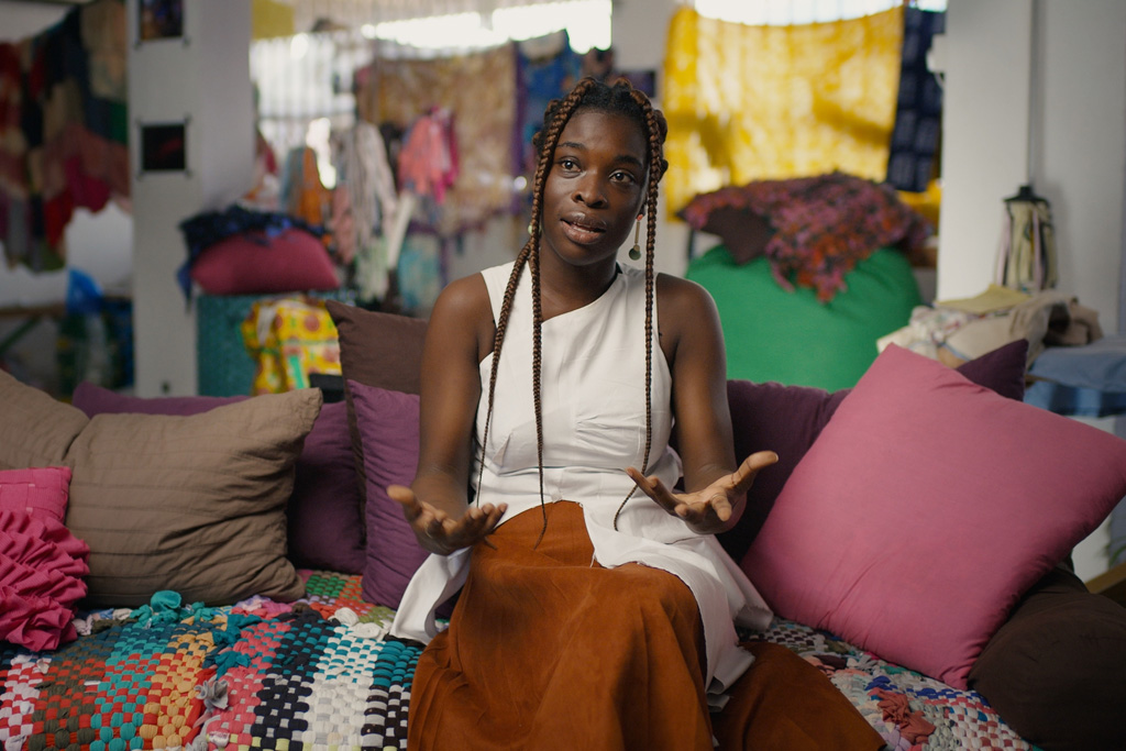 A woman surrounded by clothing