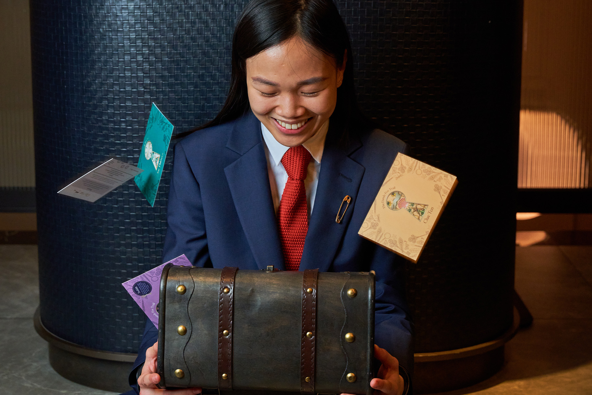 Concierge opening the box with clues